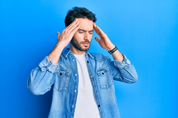 Young hispanic man wearing casual clothes with hand on head, headache because stress. suffering migraine.