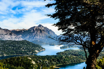 Beautiful lake landscape in the middle of mountains surrounded by pine trees and rocks everywhere....