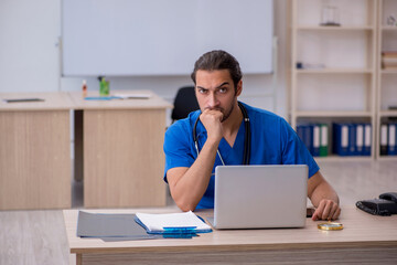 Young male doctor working in the clinic