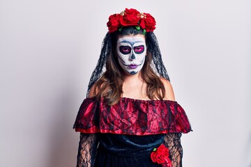 Young woman wearing day of the dead costume over white skeptic and nervous, frowning upset because of problem. negative person.