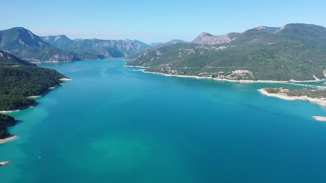 Serene summer landscape of Lake Serre-Poncon, artificial lake surrounded by French Alps, Provence-Alpes-Cote d Azur region