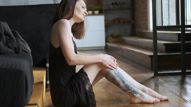 portrait of a charming woman in a nightie in the morning by the bed