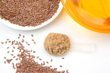 ground flaxseed on a white background. vitamins and healthy food
