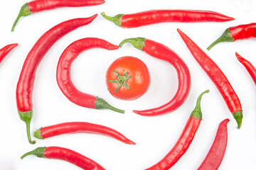 Red hot chili peppers and tomato on a white background. Vitamin vegetable food