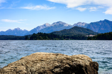 Beautiful beach landscape with rocks mountains and pine trees. Lake in Barilochem Argentina. Vacation landscape