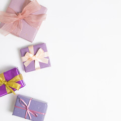 Purple color gift boxes on white background. flat lay, top view, copy space