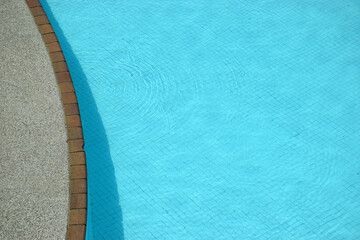 An abstract image of an inviting light blue swimming pool