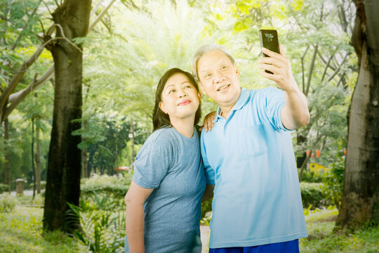 Elderly couple taking a selfie after exercising