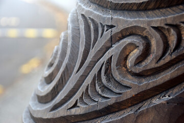 Close up detail of a carved wooden koru pattern