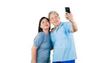 Romantic old couple taking a selfie photo on studio