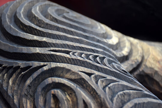 Close up detail of a carved wooden koru pattern