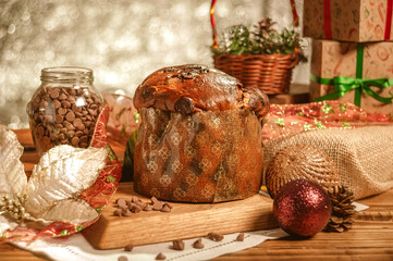 Chocolate panettone  on wooden table with christmas ornaments