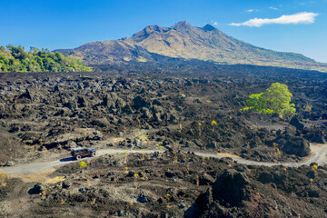 Black car driving on slopes of Batur volcano