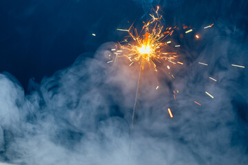 fire sparkler in dense smoke, abstract Christmas firework background