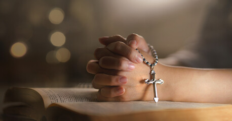 christian woman hand on holy bible worship to god holding cross rosary