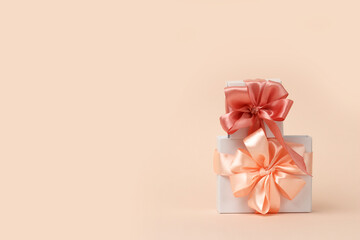 Valentine's day concept. Happy womens day design template. A decorative white gift boxes with a peach bow. Copy space