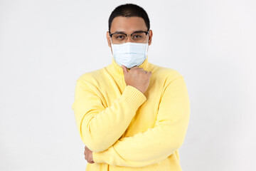 A man wearing protective mask wearing a yellow shirt, white background
