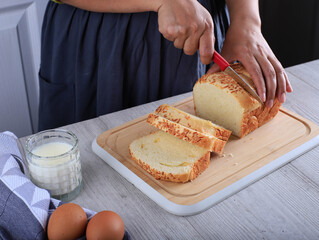 Female Chef Hold Knife to Cut or Slicing White Japanese Brioche Hokkaido Bread with Cheese Topping