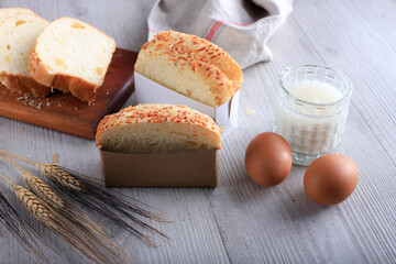 Slice Homemade Hokkaido Milk White Bread (Japanese Brioche) with Cheese on Wooden Board, Served with Egg and Milk