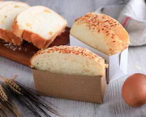 Slice Homemade Hokkaido Milk White Bread (Japanese Brioche) with Cheese on Wooden Board, Served with Egg and Milk