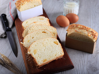 Slice Homemade Hokkaido Milk White Bread (Japanese Brioche) with Cheese on Wooden Board, Served with Egg and Milk