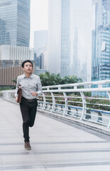 Business people holding a briefcase running on the bridge in a hurry 