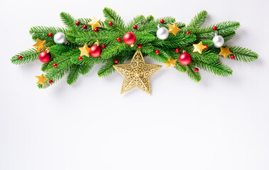 Fototapeta na wymiar Christmas garland fir tree branches decorated balls and confetti stars, top view overhead festive Xmas decoration and ornaments isolated on white background, New year card concept