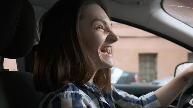 Happy Woman Driving In Car And Singing