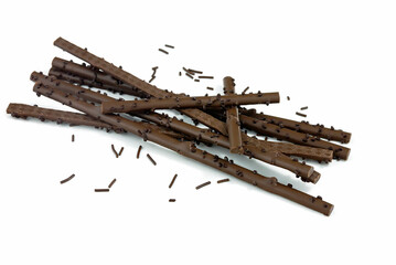 Milk chocolate brushwood, sweet delicious dessert with chocolate sprinkles.