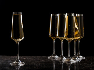 One wine-filled glass standing apart from the others.