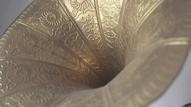 Abstract of gold metallic horn of vintage gramophone. Close-up shot