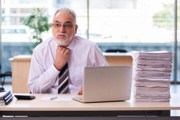 Aged businessman employee unhappy with excessive work