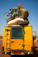 Old overloaded public transport with goods on the roof in Mali. Africa