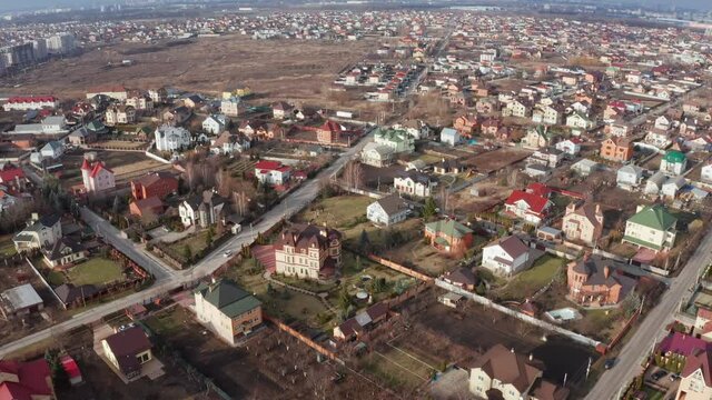Push Out Reveal Drone Shot of residential area with housing in the suburbs of the city - low-density development outside the city. Drone flight over cottages, duplexes and multi-family homes. 