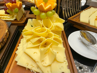 Slice of Swiss cheese on a buffet
