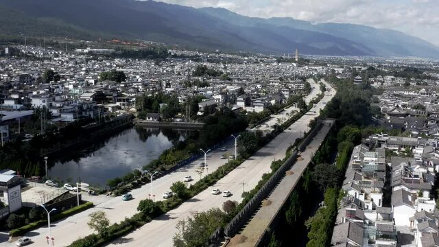 Dali Ancient City wall beside modern urban highway, China, aerial view