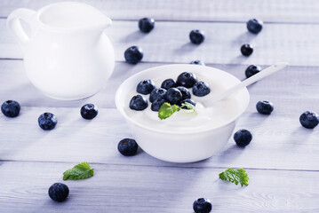 yogurt and blueberry on white wooden table. Healthy аnd tasty  breakfast