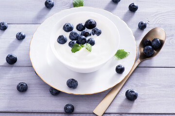 yogurt and blueberry on white wooden table. Healthy аnd tasty  breakfast