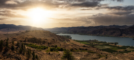 Aerial panoramic landscape view of Osoyoos Lake. Dramatic Colorful Sunset Sky. Located in the...