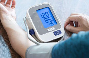 Man check blood pressure monitor and heart rate monitor with digital pressure gauge. Health care and Medical concept