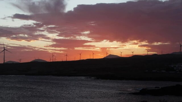A spectacular sunset over The Abades town with the turbines in the distance, Tenerife