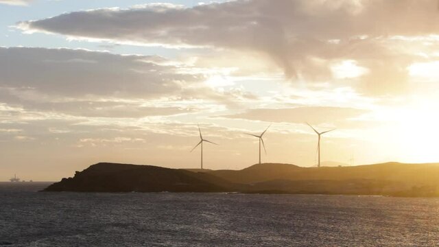 A spectacular sunset with the turbines in the distance beside the coast, Tenerife