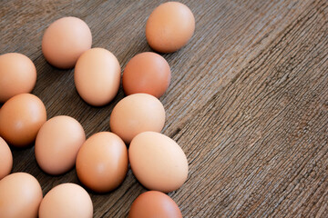 Close-up chicken eggs on wooden background.