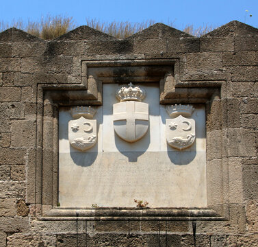 Coats of arms carved on the wall of Gate of Saint Athanasios, fortifications of Rhodes. Rhodes, Greece