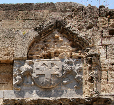 Coats of arms carved on the wall of Gate of Saint Athanasios, fortifications of Rhodes. Rhodes, Greece