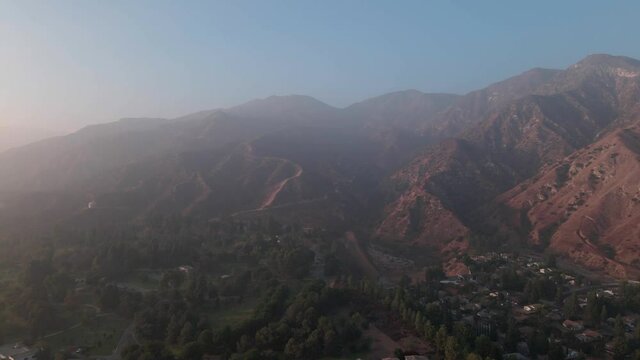 Aerial shot of San Fernando valley park and mountains during sunset with mist at Sylmar, California in 4k.