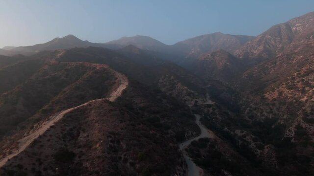 Aerial shot of San Fernando Valley mountains during sunset push back in 4k, at Sylmar, California USA