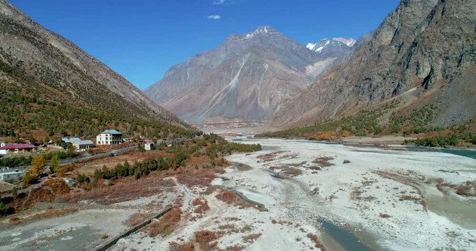 Small town on dry and rocky mountain foothills. Unknown and beautiful travel destination in Spiti, Himalayas, India