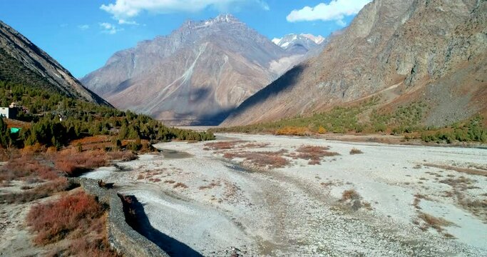 Bright sunny day in a dry rocky mountain valley. Himalayan village vibrant autumn season aerial