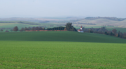 Green landscape, autumn Moravian landscape, fields, view of the village and the church.